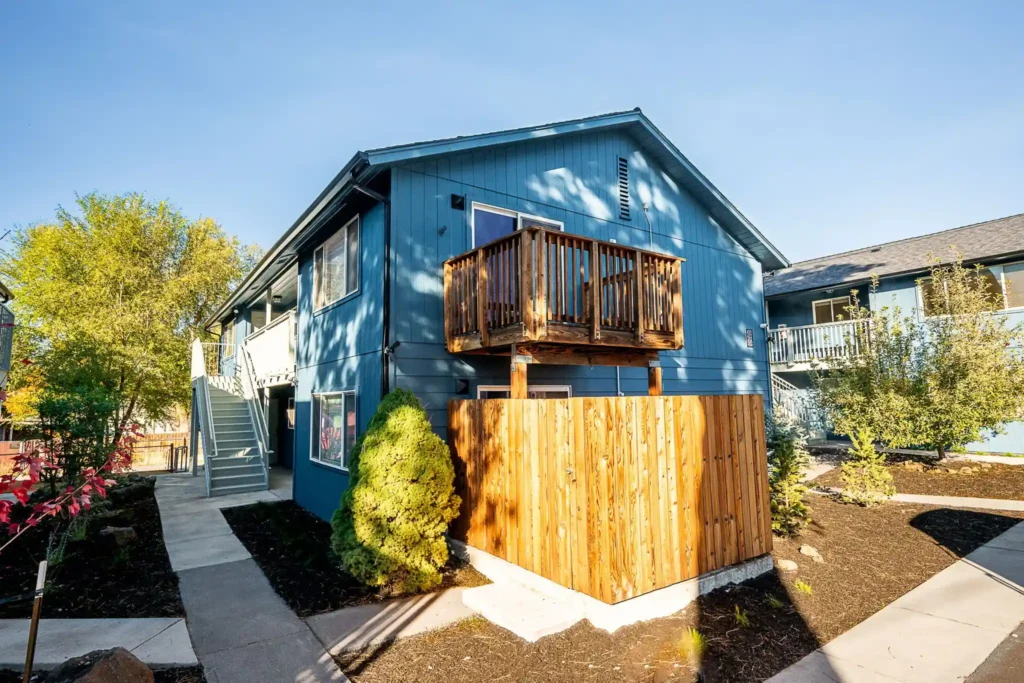 Renovated apartment complex in Bend, Oregon featuring updated exterior paint, landscaping improvements, private patios, and enhanced curb appeal.
