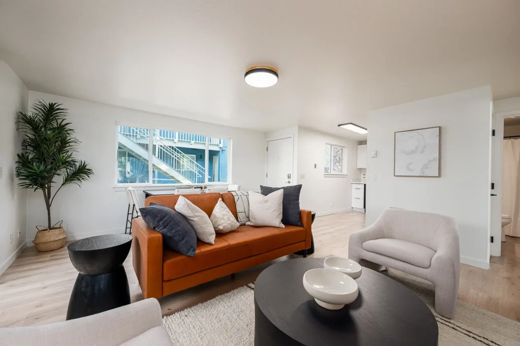 Updated apartment living room in Bend, Oregon featuring modern flooring, fresh finishes, contemporary staging, and improved tenant appeal.